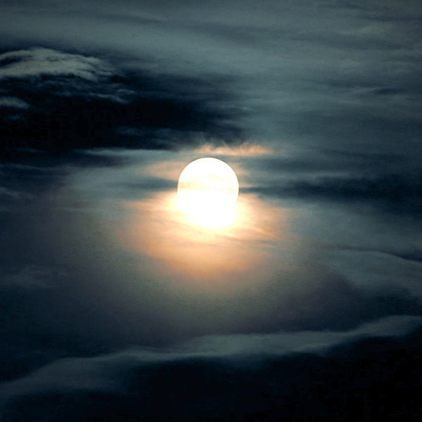 Full hunters moon in cloudy sky