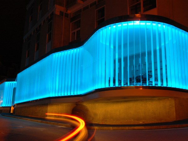 Light Flow is an art light illuminated façade in blue and green colours of the sea at the Exchange Gallery by Peter Freeman